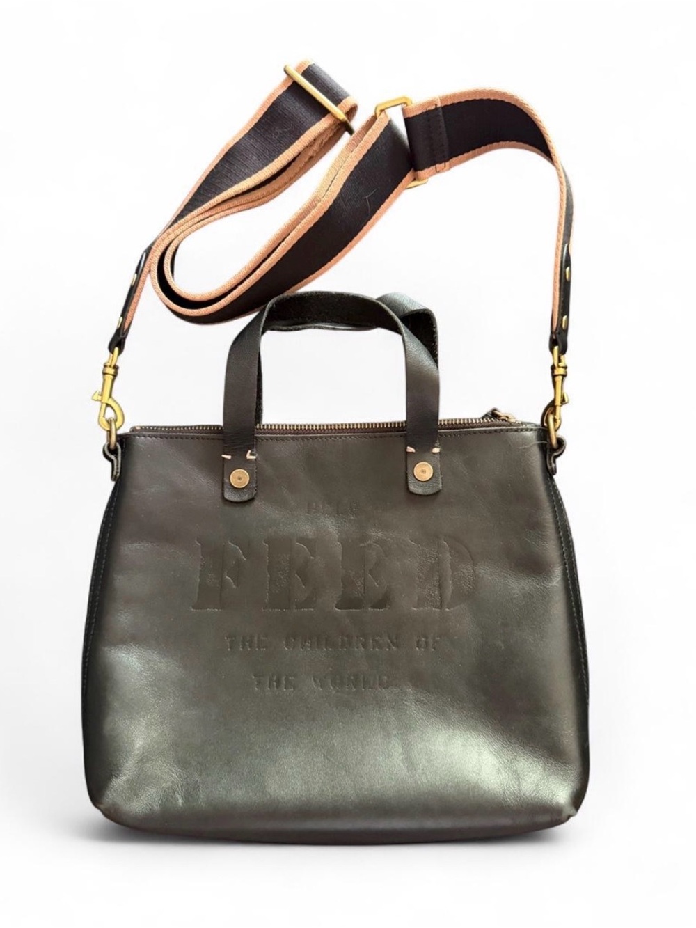 FEED the children black leather tote bag with gold hardware and embossed text.